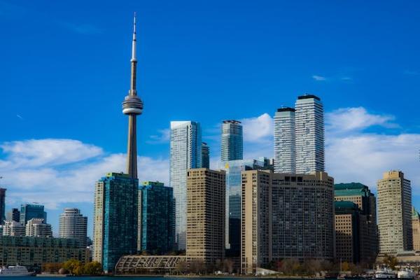 Skyline of Toronto including buildings and the tower from the water.